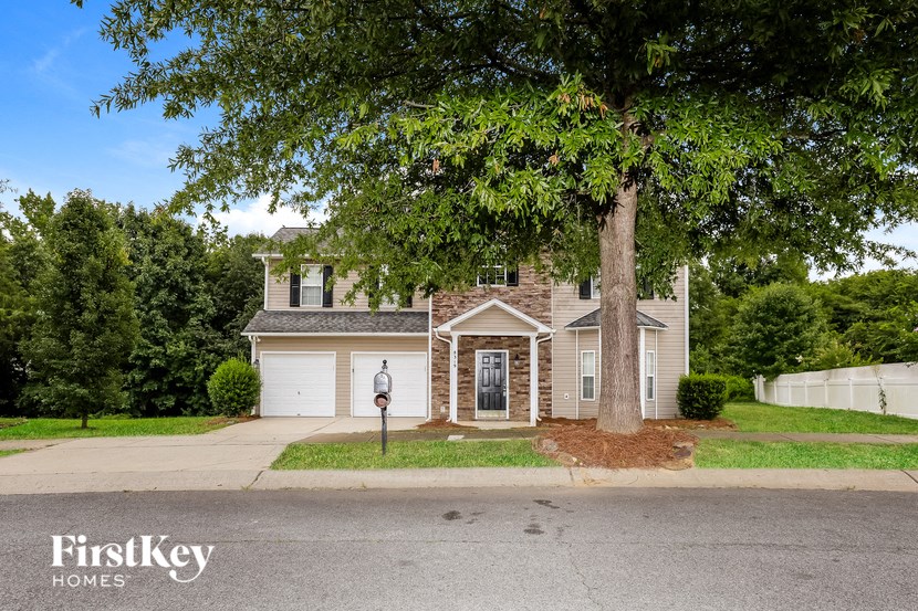 A house with a tree in front of it.