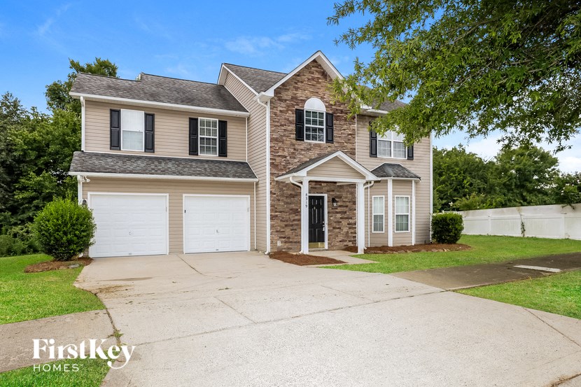 A two-story house with a garage is for sale.