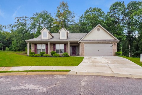 a house with a driveway and a lawn