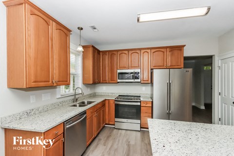 A kitchen with wooden cabinets and stainless steel appliances.