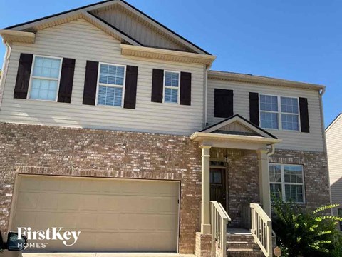a house with a garage door in front of it
