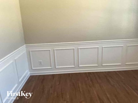 a small room with white walls and wooden floors