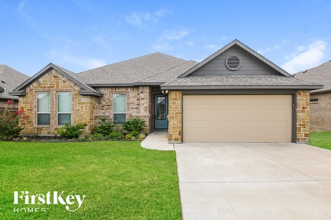 a home with a driveway and a garage door