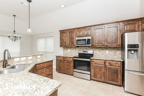 a kitchen with wooden cabinets and stainless steel appliances