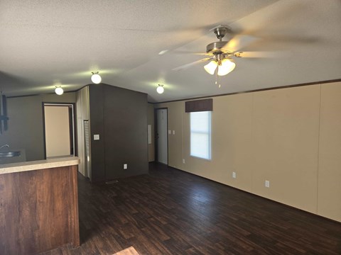 A room with a ceiling fan and lights.