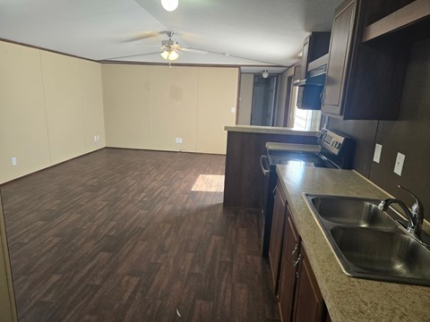 A kitchen with a sink and a fan.