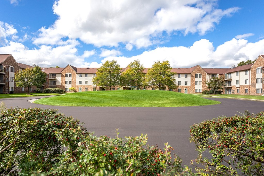 an empty roundabout in front of an apartment building