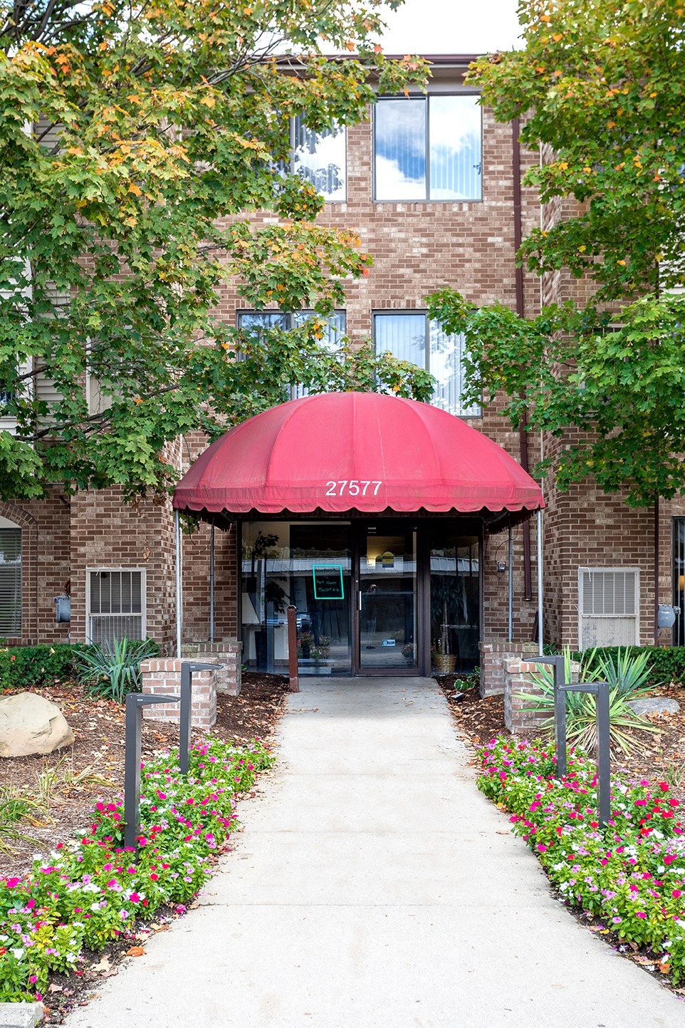 a red umbrella in front of a brick building