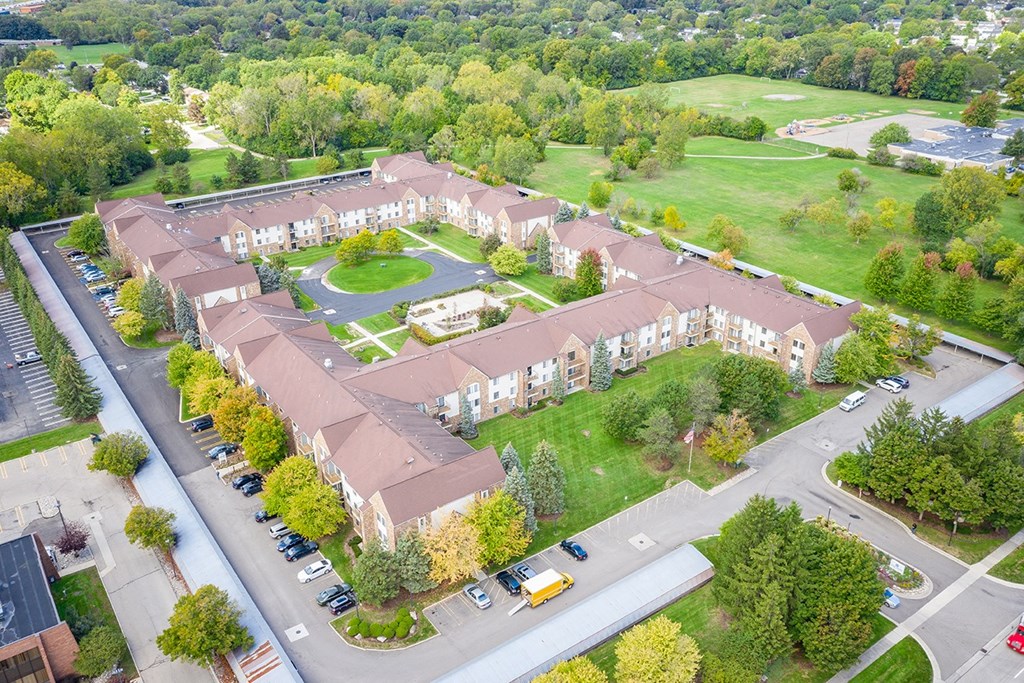 an aerial view of an apartment complex with a parking lot