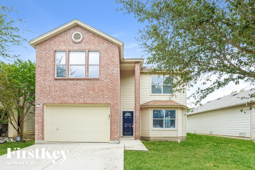 A brick house with a black door and a garage.