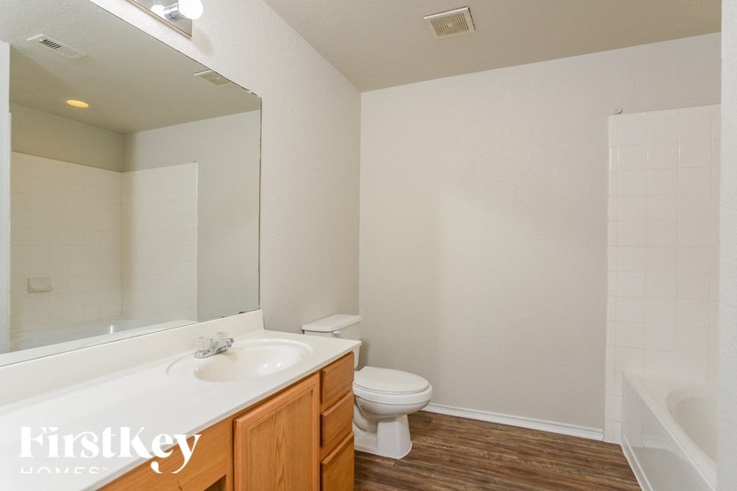 A white sink and toilet in a small bathroom.