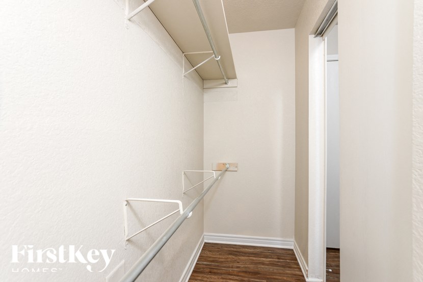 A white wall with a staircase and a door.