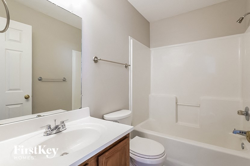 a bathroom with a sink and a toilet and a shower