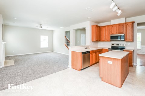 A kitchen with orange cabinets and a white countertop.