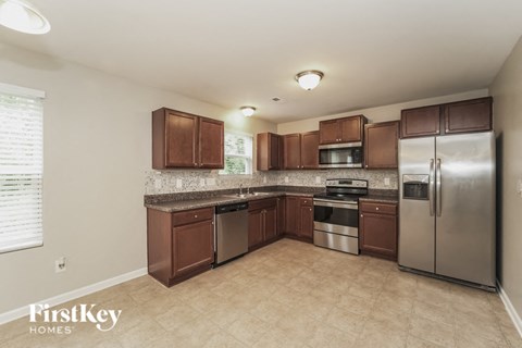 a kitchen with stainless steel appliances and wooden cabinets