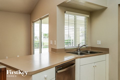 a kitchen with a sink and a window