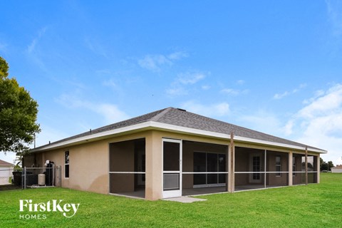 a manufactured home with a porch and a grass yard