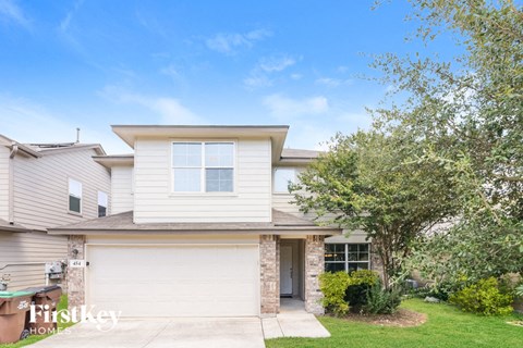 a white house with a tree in front of it