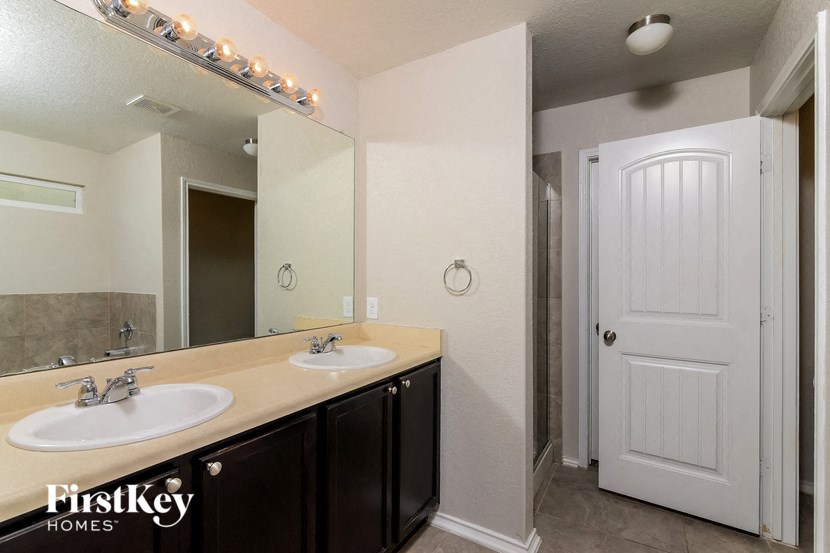 a bathroom with two sinks and a large mirror