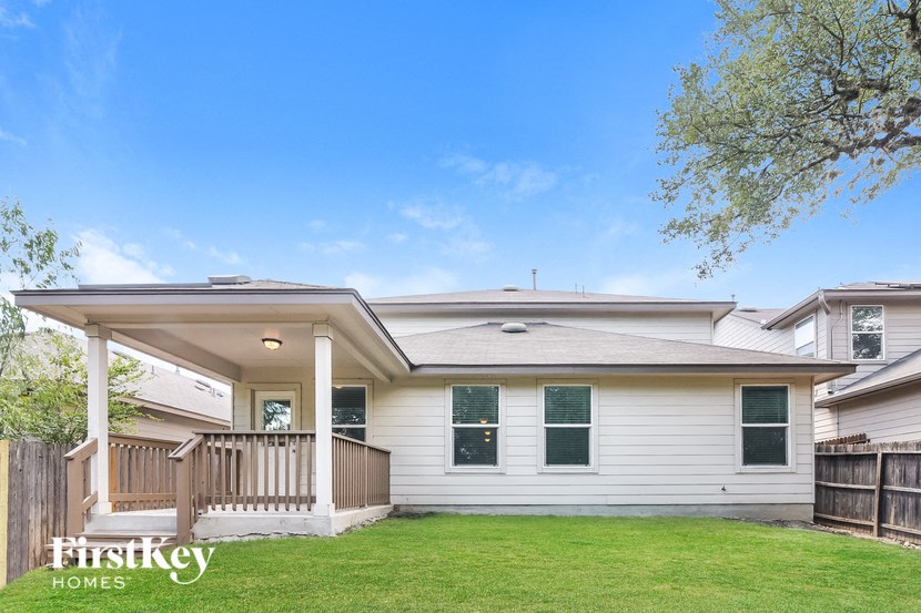 a white house with a porch and a green lawn