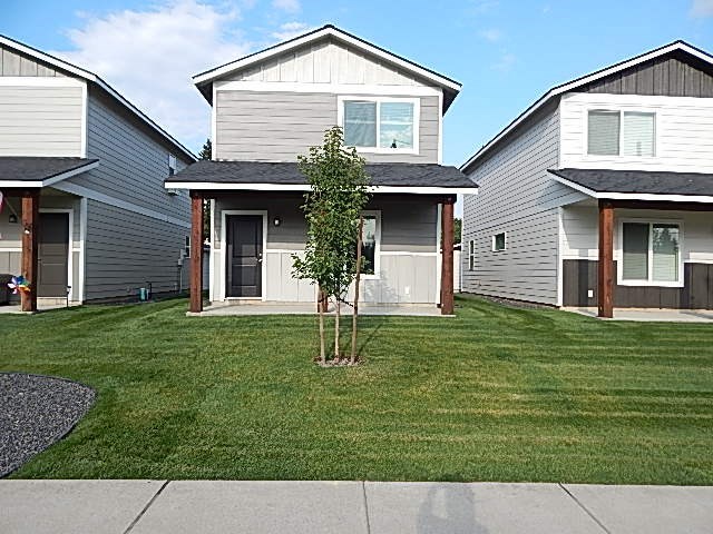 a house with a tree in the front of it