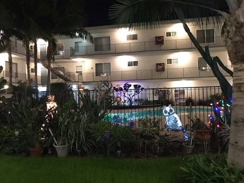 A pool with a lit up snowman in the background.