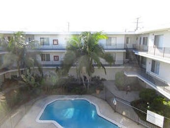 A pool in a backyard surrounded by a fence.