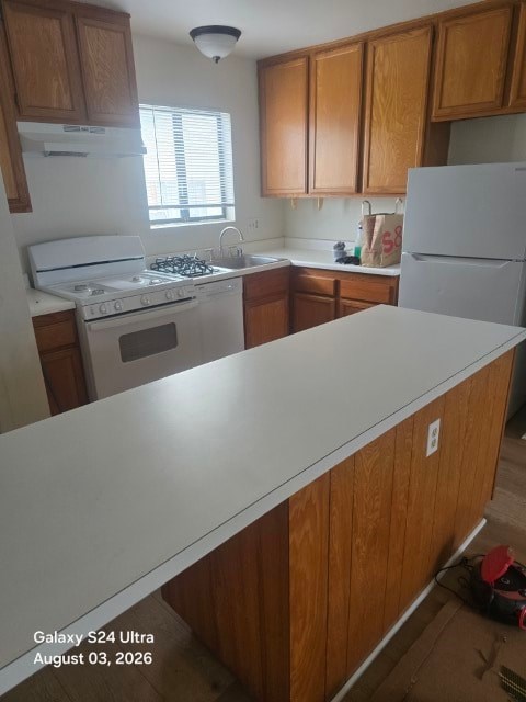 A kitchen with wooden cabinets and a white island.