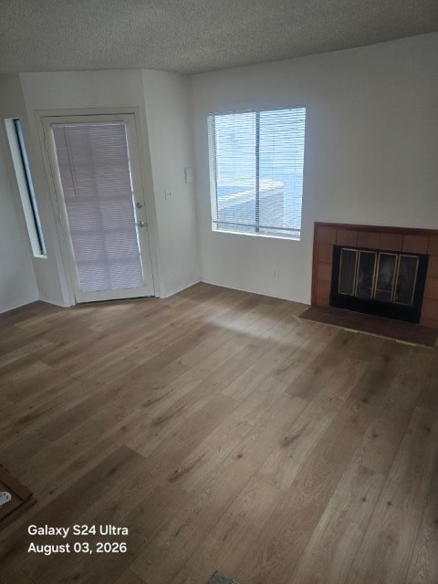 A room with a fireplace and wood flooring.