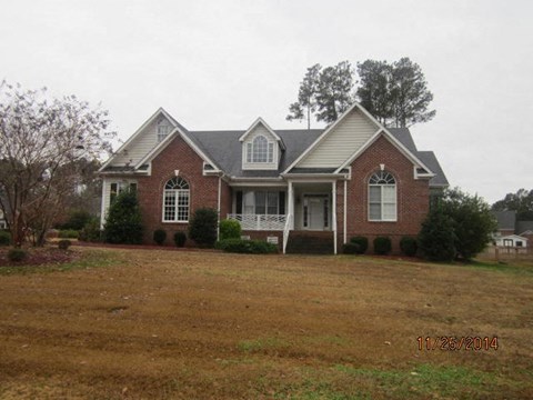 a house with a large yard in front of it