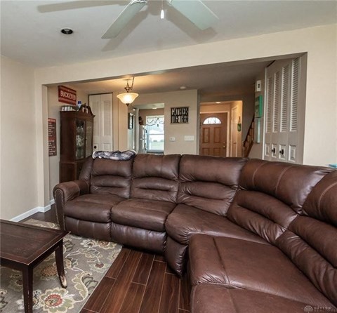 A brown leather sectional sofa in a living room.
