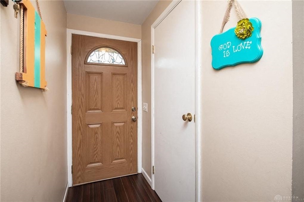 A wooden door with a glass window and a sign that says "pop love" on the wall.