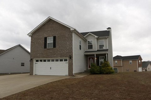 a brick house with a white garage door