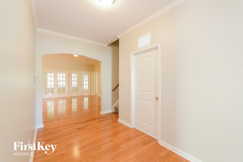 A room with wooden floors and a white door.