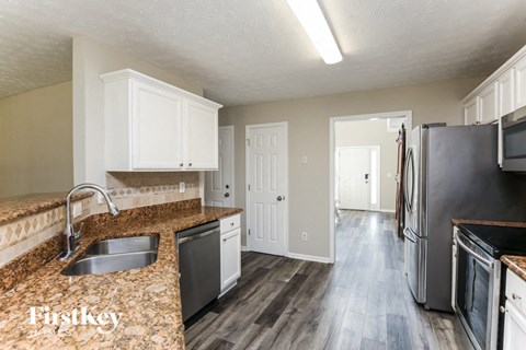 a kitchen with granite counter tops and stainless steel appliances