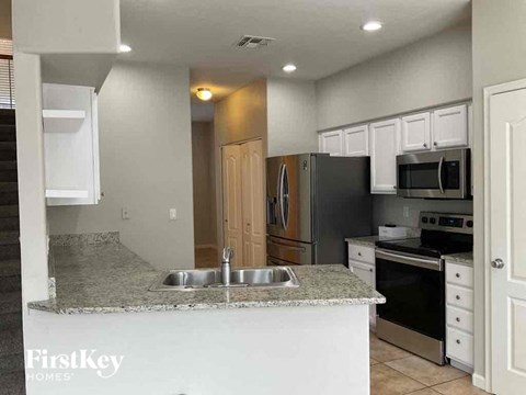 a kitchen with a granite counter top and a sink