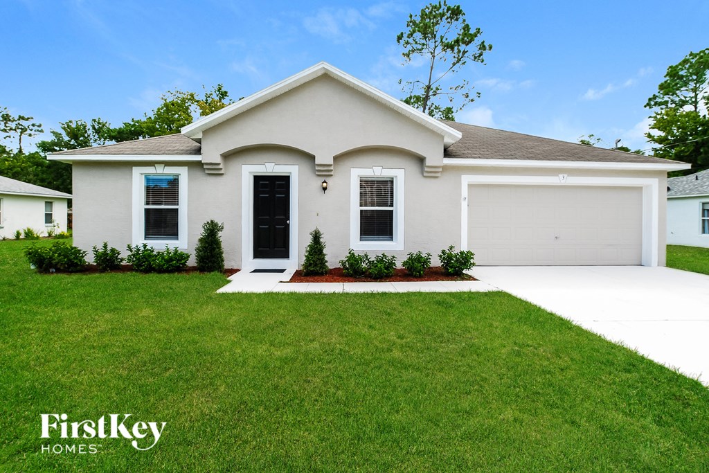 a white house with a lawn in front of it