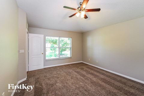 the master bedroom is spacious and has a ceiling fan