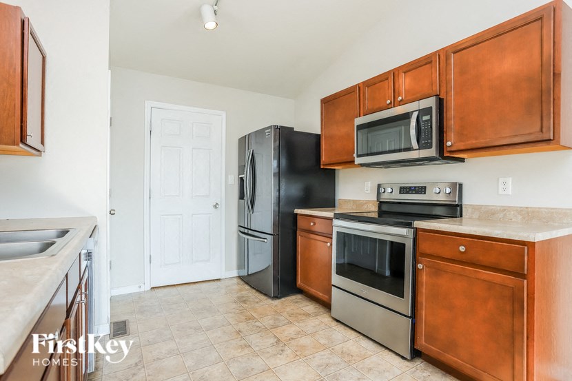 a kitchen with stainless steel appliances and wooden cabinets