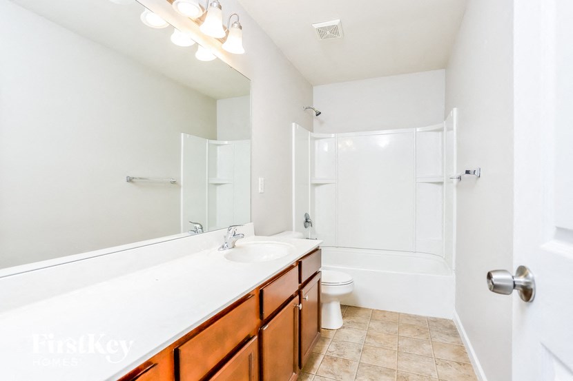 a bathroom with a sink and a toilet and a shower