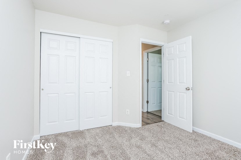 a bedroom with two closets and a door to a hallway