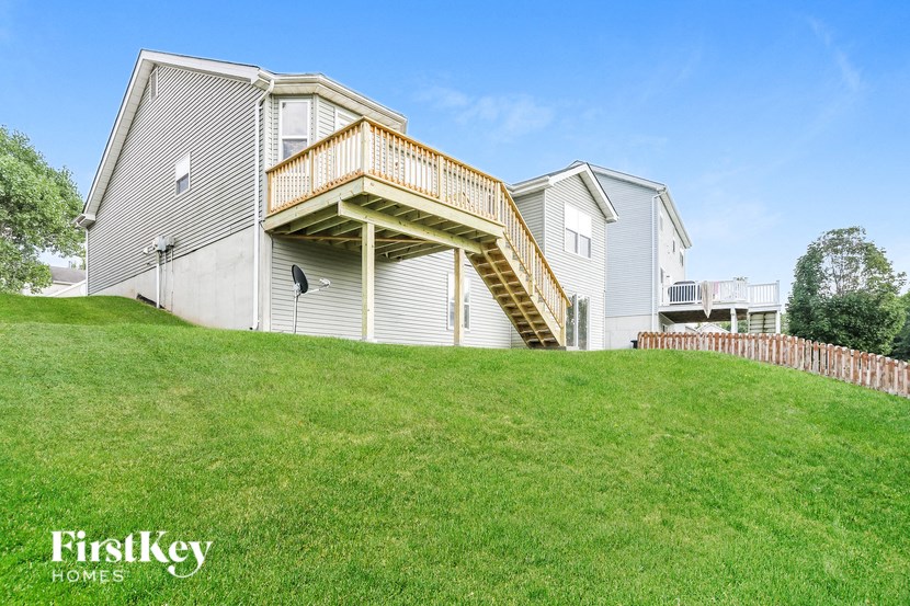 a house with a deck on top of a hill