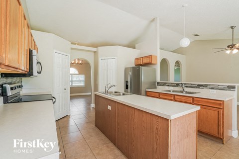 a kitchen with wooden cabinets and a white counter top