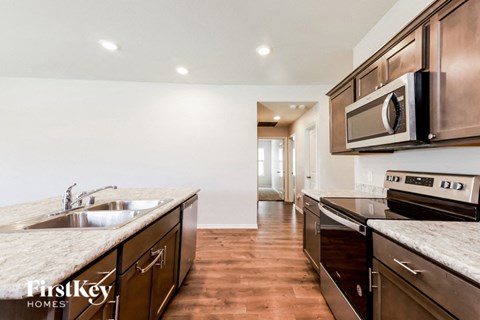 a modern kitchen with stainless steel appliances and marble counter tops