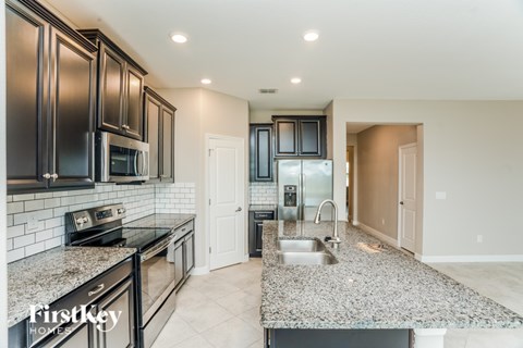 A kitchen with granite countertops and stainless steel appliances.