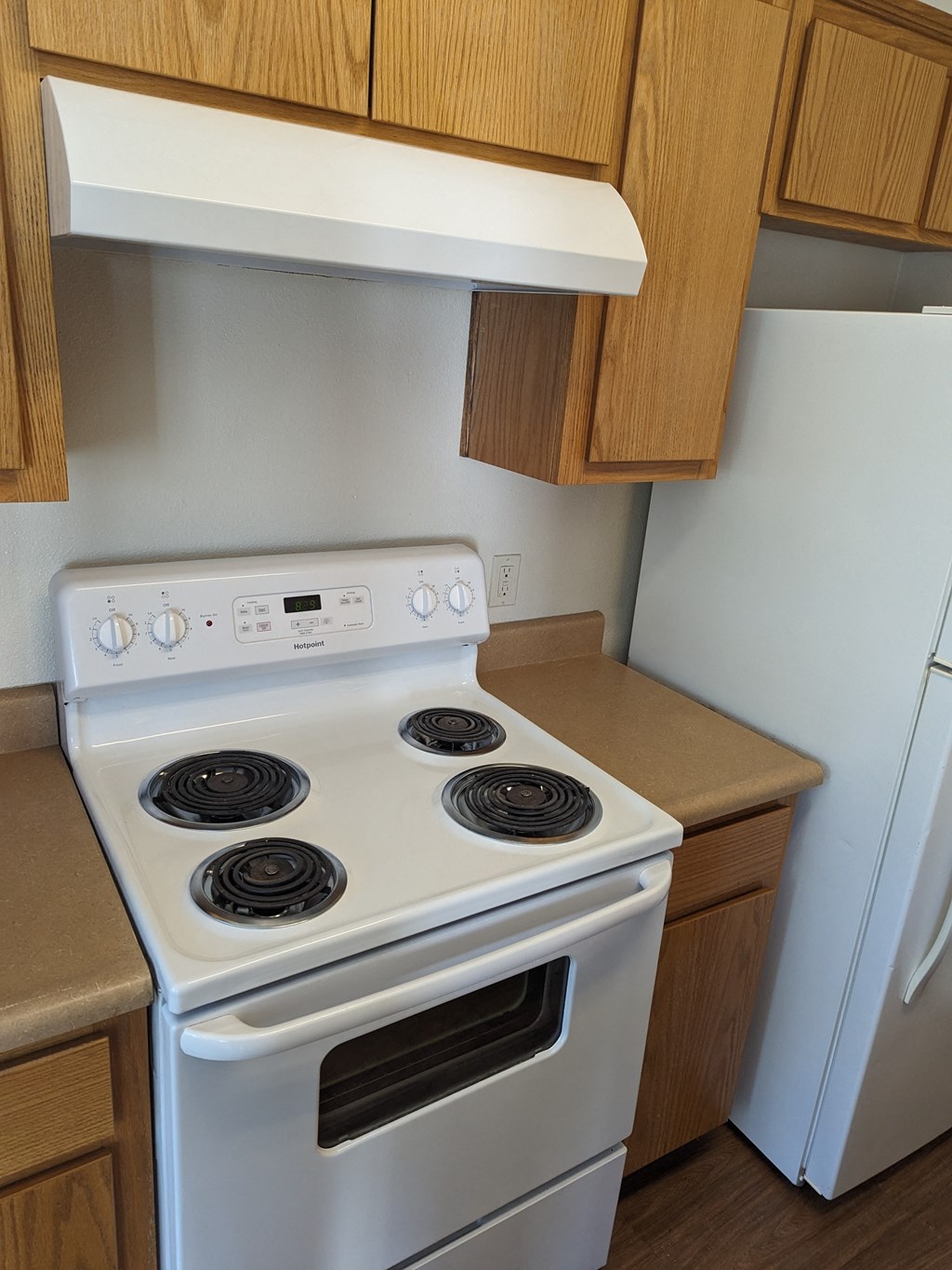 a kitchen with a stove and a white stove top oven