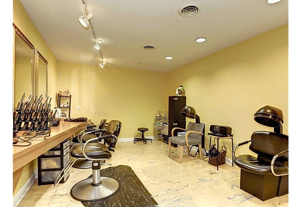 a barbershop with chairs and a counter in a nail salon