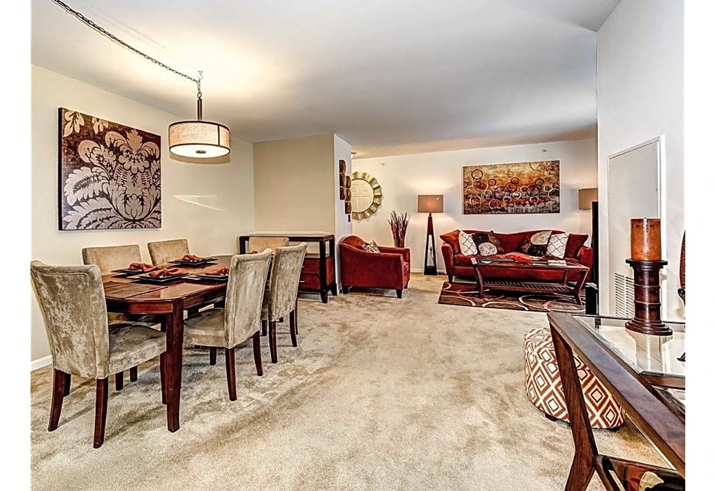 a living room and dining room with a table and chairs