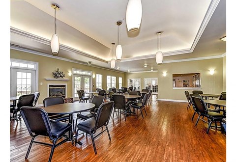a large dining room with tables and chairs and a fireplace