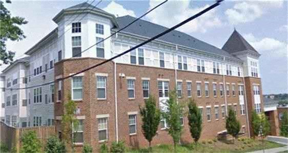 a large brick building with a power line in front of it